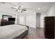 The main bedroom has a ceiling fan, dresser with TV, and sliding door closet at 405 W Monte Way, Phoenix, AZ 85041