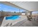 Covered outdoor patio with view of inground pool in backyard at 405 W Monte Way, Phoenix, AZ 85041