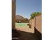 Landscaped backyard featuring gravel, artificial turf, and a built-in outdoor grill, perfect for entertaining at 43241 W Kristal Ln, Maricopa, AZ 85138
