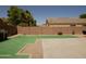 Wide shot of a backyard with a built-in grill, patio, block wall and desert landscaping at 43241 W Kristal Ln, Maricopa, AZ 85138