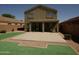 Backyard view showing patio, covered porch, and the rear elevation of the house at 43241 W Kristal Ln, Maricopa, AZ 85138