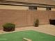 Artificial turf and low maintenance gravel yard features a block wall perimeter at 43241 W Kristal Ln, Maricopa, AZ 85138