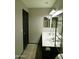 Neutral bathroom featuring a dual sink vanity, tile floors, and a walk-in shower at 43241 W Kristal Ln, Maricopa, AZ 85138