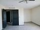 Light and airy bedroom with closet and black doors at 43241 W Kristal Ln, Maricopa, AZ 85138