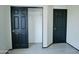 Bedroom featuring neutral walls, wood-look floors, and a black closet door at 43241 W Kristal Ln, Maricopa, AZ 85138