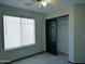 Bedroom with neutral walls, wood-look floors, a window, and a closet at 43241 W Kristal Ln, Maricopa, AZ 85138