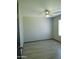 This bedroom has neutral walls, a ceiling fan, a window, and wood-look floors at 43241 W Kristal Ln, Maricopa, AZ 85138