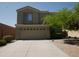 Two-story home featuring an attached two-car garage and easy-care desert landscaping for water conservation at 43241 W Kristal Ln, Maricopa, AZ 85138