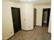Neutral hallway with tiled floor and multiple doorways leading to other rooms, showcasing the home's layout at 43241 W Kristal Ln, Maricopa, AZ 85138