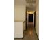 Bright hallway featuring wood-look vinyl flooring and fresh neutral paint at 43241 W Kristal Ln, Maricopa, AZ 85138