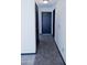 Hallway featuring tile flooring and dark doors at 43241 W Kristal Ln, Maricopa, AZ 85138