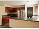Kitchen featuring dark cabinets, tile flooring, and a breakfast bar at 43241 W Kristal Ln, Maricopa, AZ 85138