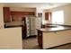 Kitchen with dark cabinets, tile flooring, and stainless steel refrigerator at 43241 W Kristal Ln, Maricopa, AZ 85138