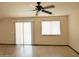 Living room featuring wood flooring and large windows with blinds at 43241 W Kristal Ln, Maricopa, AZ 85138
