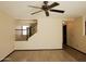 Open living room showcases wood flooring, a ceiling fan, and staircase at 43241 W Kristal Ln, Maricopa, AZ 85138