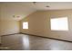 Spacious living room with wood-look vinyl floors, vaulted ceilings and ample natural light at 43241 W Kristal Ln, Maricopa, AZ 85138