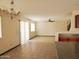 Open living and dining area with tile floors, ceiling fan, and sliding glass door at 43241 W Kristal Ln, Maricopa, AZ 85138