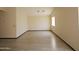 Bright living room with wood-look vinyl flooring and fresh neutral paint at 43241 W Kristal Ln, Maricopa, AZ 85138