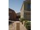 View of the side yard with desert landscaping between the house and detached garage in the rear at 43241 W Kristal Ln, Maricopa, AZ 85138