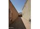View of the narrow side yard featuring desert landscaping between two homes at 43241 W Kristal Ln, Maricopa, AZ 85138