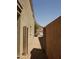 View of side yard with gravel and block wall, leading to potential backyard space at 43241 W Kristal Ln, Maricopa, AZ 85138