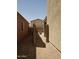 View from side yard with gravel and block wall, leading to backyard and house at 43241 W Kristal Ln, Maricopa, AZ 85138