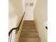 A look at an interior staircase with wood-look steps, ascending to the upper level, showing natural light at 43241 W Kristal Ln, Maricopa, AZ 85138