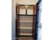 Open storage cabinets with brown trim for storage at 43241 W Kristal Ln, Maricopa, AZ 85138