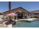 Private backyard featuring a pool with steps, patio, desert landscaping, and umbrellas at 441 E Pinto Dr, Gilbert, AZ 85296