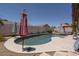 Backyard with a private pool surrounded by lounge seating and desert landscaping at 441 E Pinto Dr, Gilbert, AZ 85296