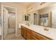 Large bathroom featuring dual sinks, vanity, shower, and large mirror at 441 E Pinto Dr, Gilbert, AZ 85296