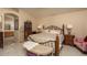 Relaxing bedroom featuring bed with an ornate frame, lamps, and neutral walls at 441 E Pinto Dr, Gilbert, AZ 85296