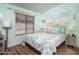 Tranquil bedroom with beach themed decor, a large window, and a comfortable queen bed at 441 E Pinto Dr, Gilbert, AZ 85296