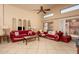 Bright living room features tile flooring, ceiling fan, and comfortable seating at 441 E Pinto Dr, Gilbert, AZ 85296