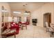 Bright living area with high ceilings, comfortable seating, and a view of the outdoor space at 441 E Pinto Dr, Gilbert, AZ 85296