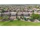 Aerial view of residences with pools and green spaces, offering a picturesque community setting at 44348 W Windrose Dr, Maricopa, AZ 85138