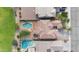 Aerial view of the property showcasing two pools, a trampoline, and lush landscaping at 44348 W Windrose Dr, Maricopa, AZ 85138