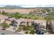 An aerial view showcases a neighborhood with well-manicured lawns, desert landscapes, and mountain views at 44348 W Windrose Dr, Maricopa, AZ 85138