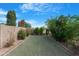 Lush backyard features verdant trees/shrubs and desert landscaping providing privacy and serenity at 44348 W Windrose Dr, Maricopa, AZ 85138