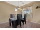 Cozy dining room with modern chandelier and dark wood table at 44348 W Windrose Dr, Maricopa, AZ 85138