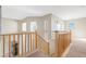 Bright loft area with carpet flooring and wood railing at 44348 W Windrose Dr, Maricopa, AZ 85138