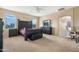 Spacious main bedroom with dark furniture, carpet flooring, and a ceiling fan at 44348 W Windrose Dr, Maricopa, AZ 85138