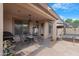 Covered patio featuring a dining area, grill, and outdoor space for entertainment at 44348 W Windrose Dr, Maricopa, AZ 85138