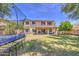 Large backyard boasting green lawn, a covered patio, and outdoor recreational equipment, creating an inviting outdoor space at 4609 E Ironhorse Rd, Gilbert, AZ 85297