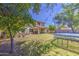 Spacious backyard featuring a well-maintained lawn, mature trees, and ample space for outdoor activities at 4609 E Ironhorse Rd, Gilbert, AZ 85297