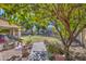 Picturesque backyard featuring a lush lawn, mature trees, stone pavers, and a covered patio, perfect for outdoor enjoyment at 4609 E Ironhorse Rd, Gilbert, AZ 85297