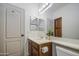 Well-lit bathroom displaying a vanity sink, toilet, and mirror with modern lighting fixtures at 4609 E Ironhorse Rd, Gilbert, AZ 85297