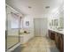 Bathroom featuring a glass-enclosed shower, tub, double sink vanity, and tile flooring at 4609 E Ironhorse Rd, Gilbert, AZ 85297