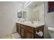 Bright bathroom featuring a double sink vanity and a large mirror at 4609 E Ironhorse Rd, Gilbert, AZ 85297