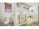Bathroom featuring a toilet, glass shower, and a soaking tub with tile flooring at 4609 E Ironhorse Rd, Gilbert, AZ 85297